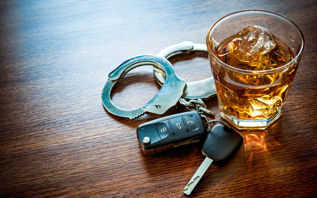 DUI image showing handcuffs, drink, and car keys